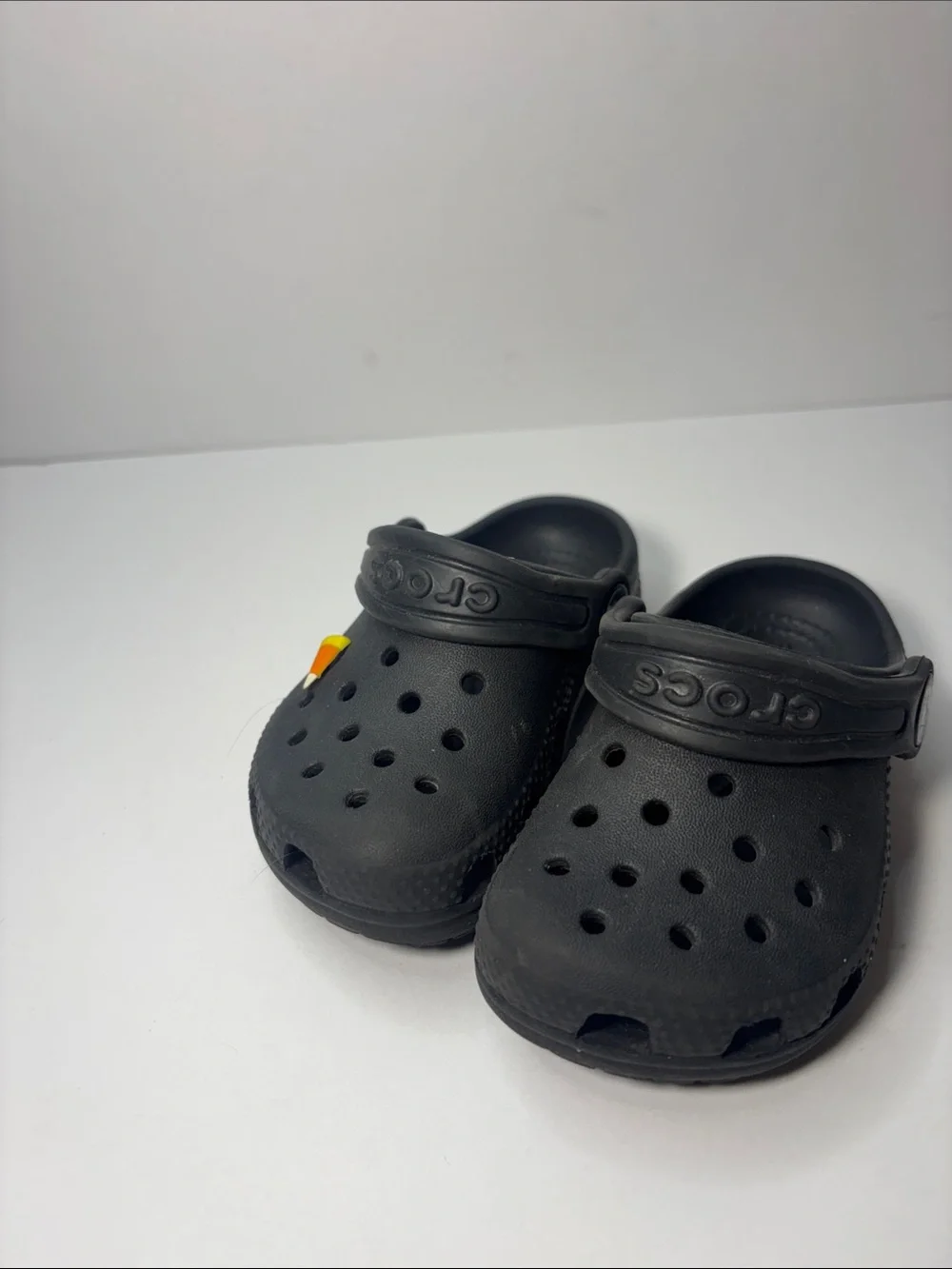 CROCS Kids Black Clogs with Orange Accent Charm